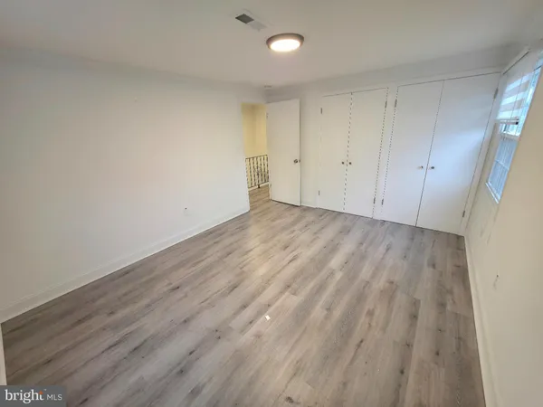 a view of room with wooden floor