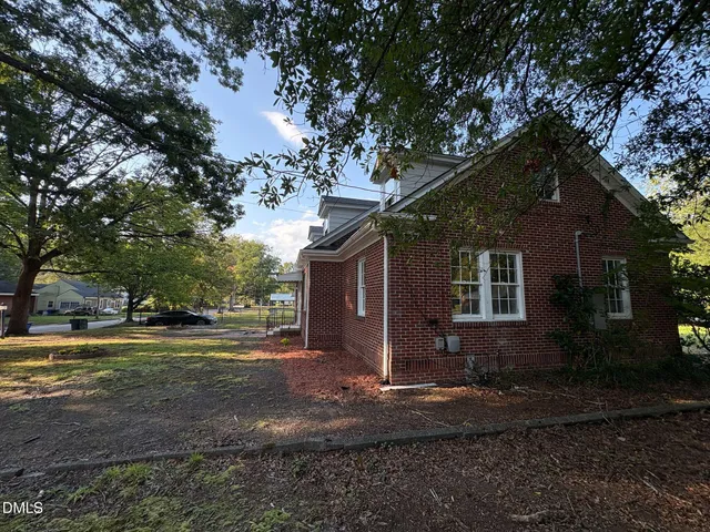 a front view of house with yard and trees