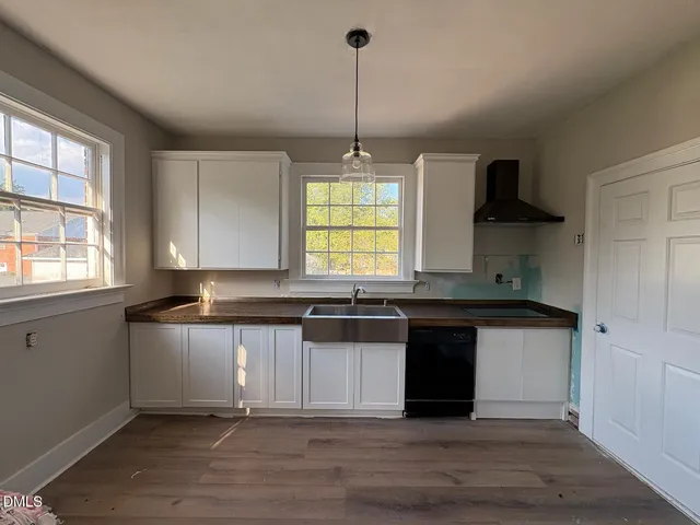 a kitchen with stainless steel appliances granite countertop a stove a sink and a wooden floors