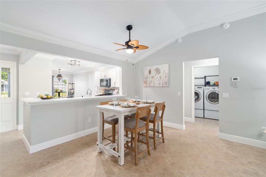 967 Livingston Loop The Villages, FL 32162 - Photo 12 of 62 a view of a dining room with furniture and a chandelier fan