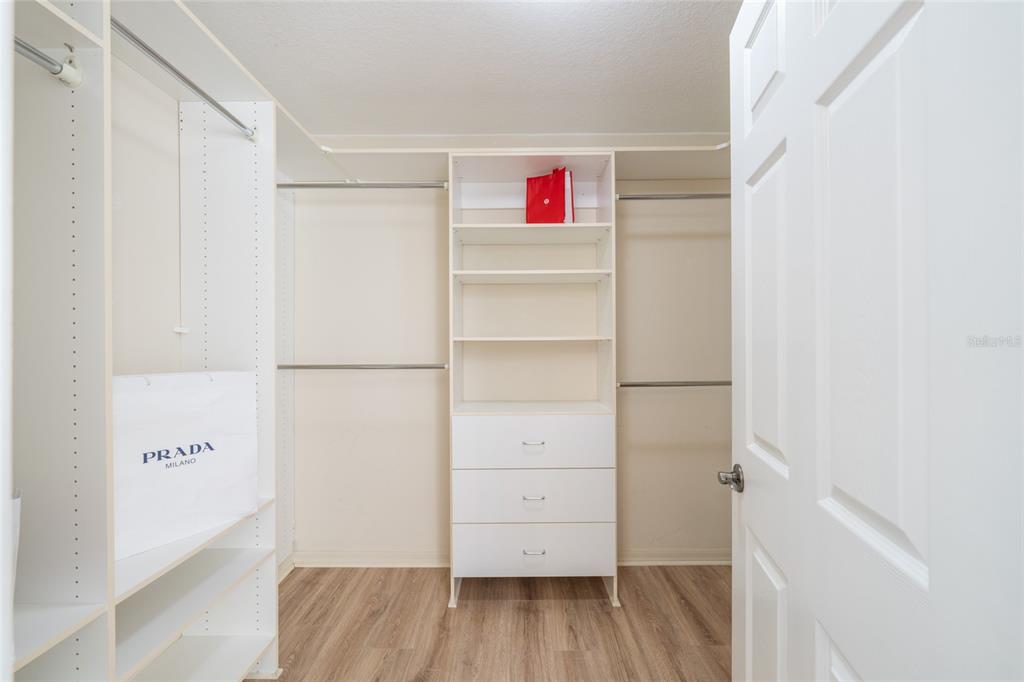 967 Livingston Loop The Villages, FL 32162 - Photo 22 of 62 a view of walk in closet with empty racks