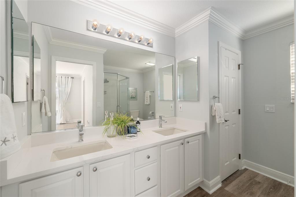 967 Livingston Loop The Villages, FL 32162 - Photo 23 of 62 a bathroom with a double vanity sink and mirror with shower