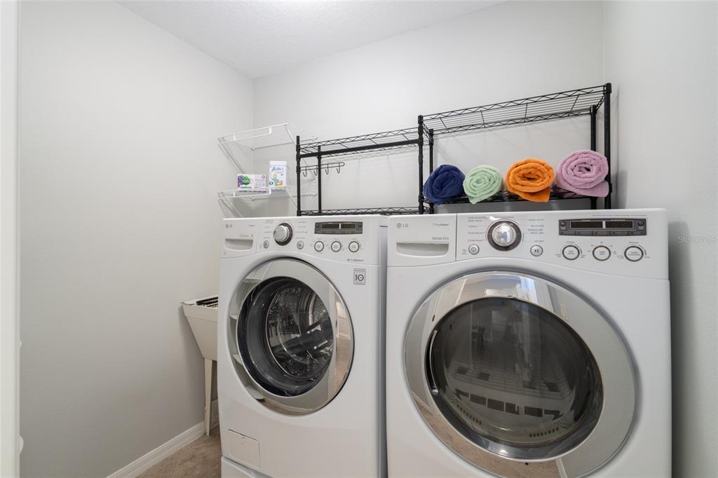 967 Livingston Loop The Villages, FL 32162 - Photo 26 of 62 a utility room with dryer and washer