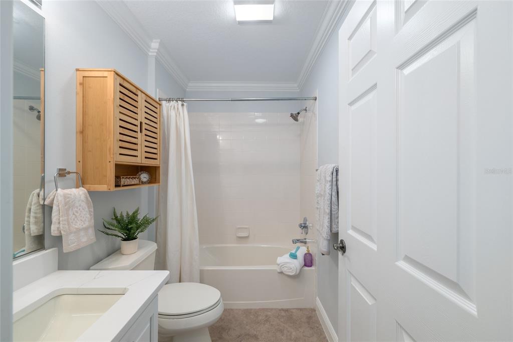 967 Livingston Loop The Villages, FL 32162 - Photo 30 of 62 a bathroom with a sink a toilet a tub and shower