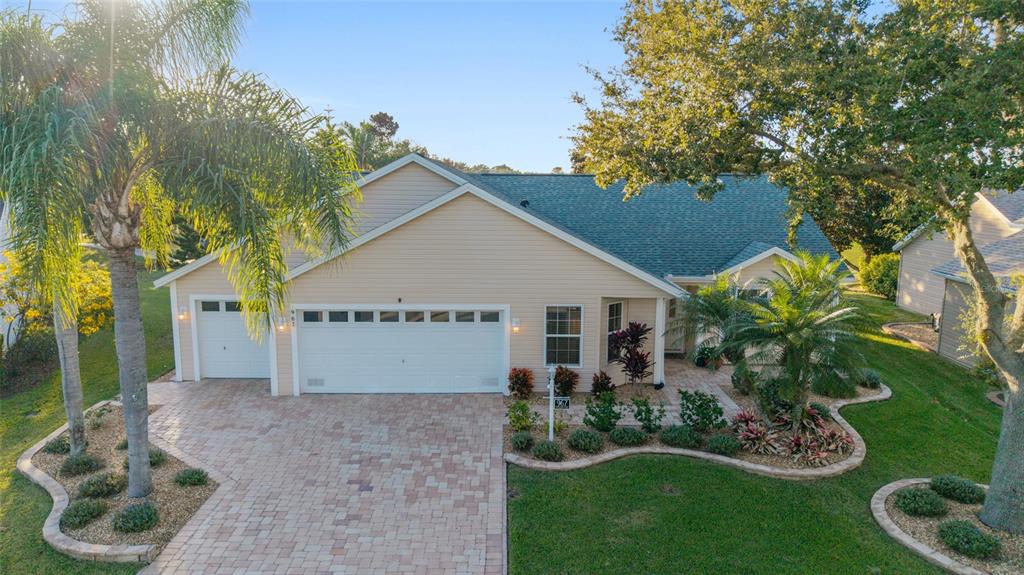967 Livingston Loop The Villages, FL 32162 - Photo 46 of 62 a view of a house with a yard and potted plants