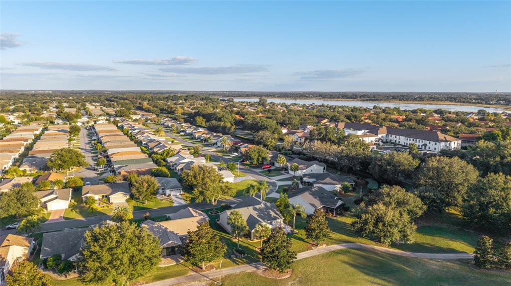 967 Livingston Loop The Villages, FL 32162 - Photo 47 of 62 an aerial view of residential building and lake