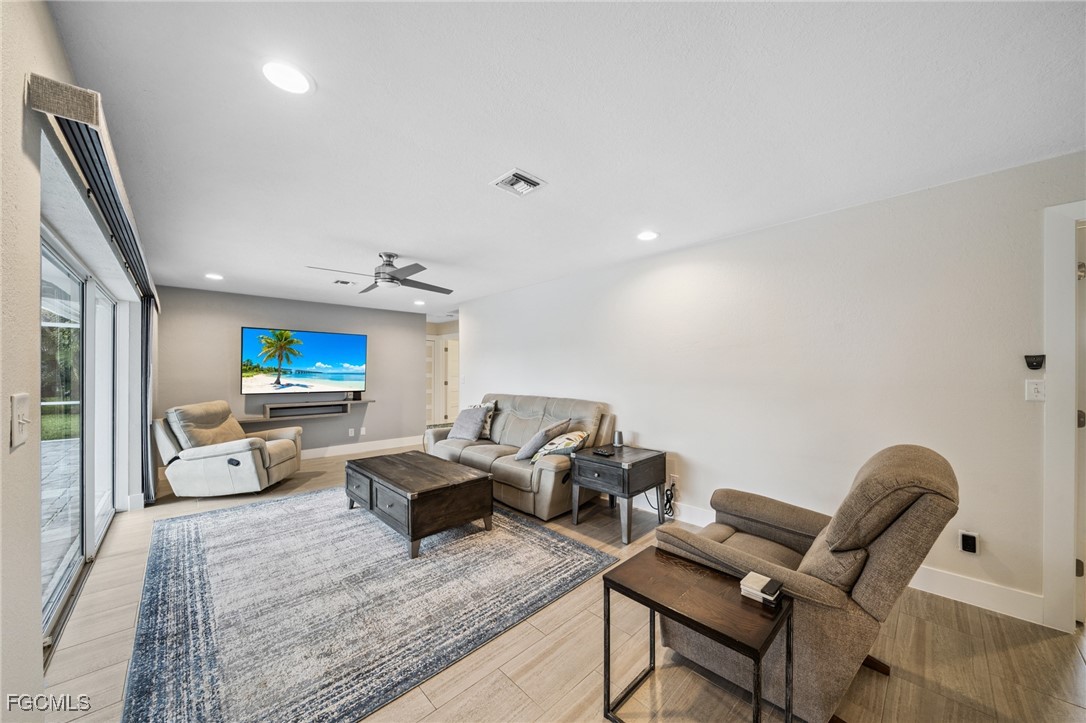 422 Coral Drive Cape Coral, FL 33904 - Photo 11 of 43 a living room with furniture and a couch