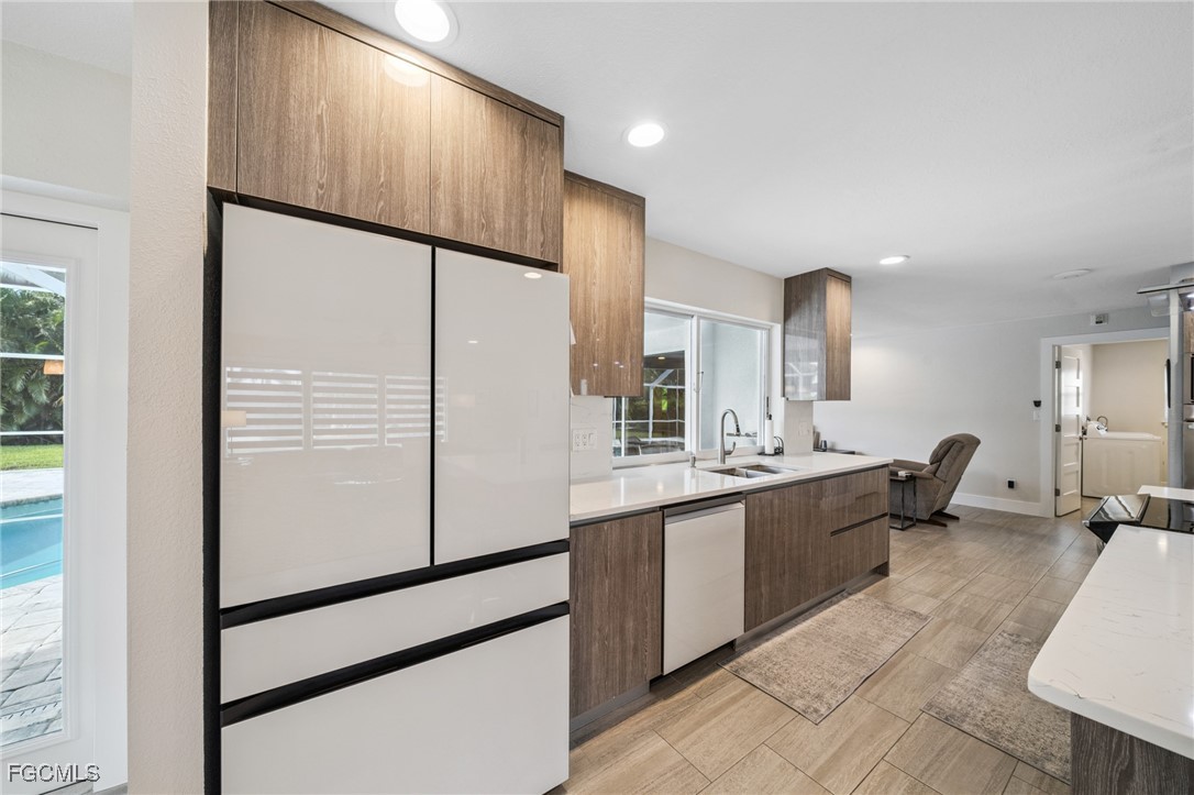 422 Coral Drive Cape Coral, FL 33904 - Photo 12 of 43 a kitchen with stainless steel appliances a refrigerator and a sink