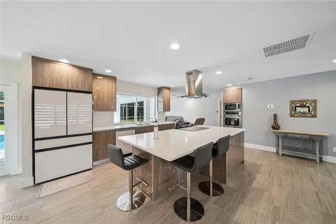 a kitchen with a table chairs refrigerator and cabinets
