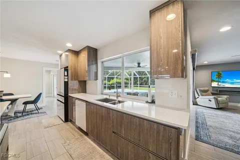 a kitchen with a table chairs stove and cabinets