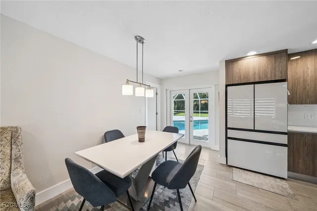 a view of a livingroom with wooden furniture and a ceiling fan