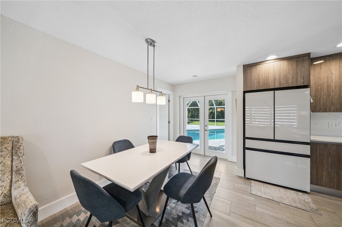 422 Coral Drive Cape Coral, FL 33904 - Photo 19 of 43 a view of a dining room with furniture window and wooden floor