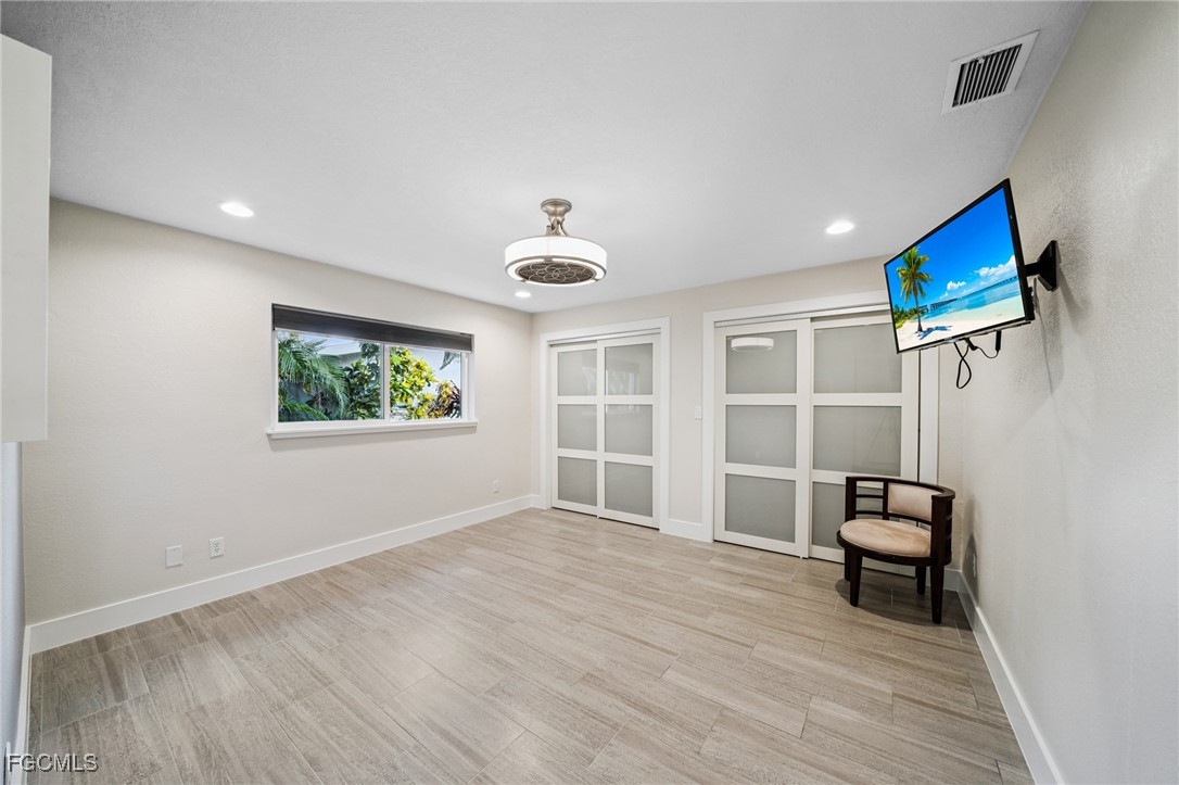 422 Coral Drive Cape Coral, FL 33904 - Photo 20 of 43 a view of a livingroom with wooden furniture and a ceiling fan