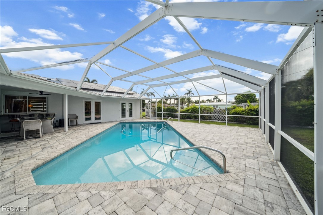 422 Coral Drive Cape Coral, FL 33904 - Photo 2 of 43 a swimming pool with outdoor seating and yard