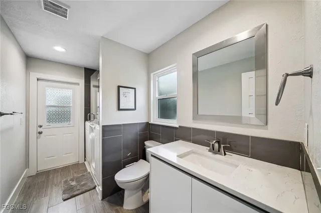 a bathroom with double vanity sink and a mirror