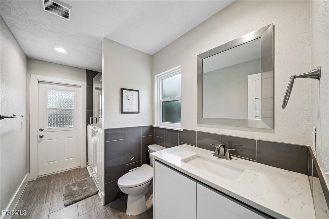 422 Coral Drive Cape Coral, FL 33904 - Photo 22 of 43 a bathroom with a sink a toilet and shower