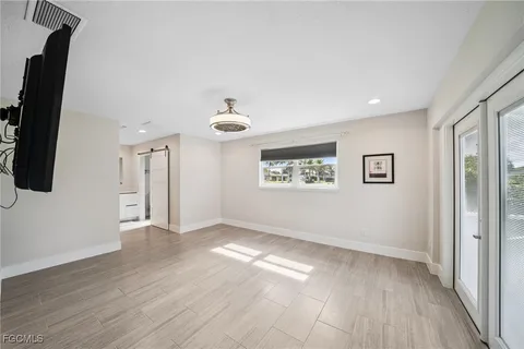 wooden floor in an empty room with a window