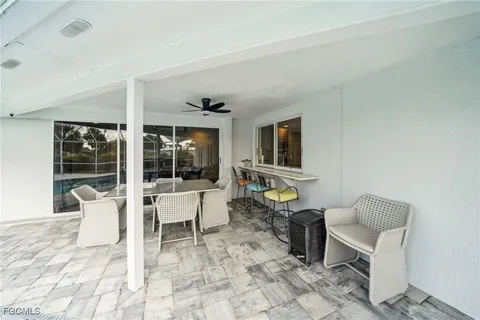 a view of house with swimming pool and porch