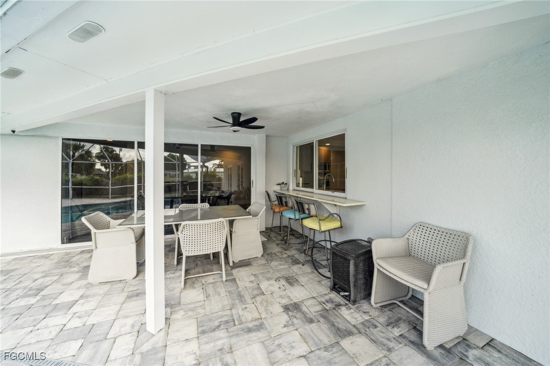 422 Coral Drive Cape Coral, FL 33904 - Photo 29 of 43 a living room with a couch and a flat screen tv