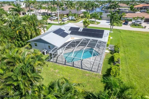 an aerial view of a house with a garden and swimming pool