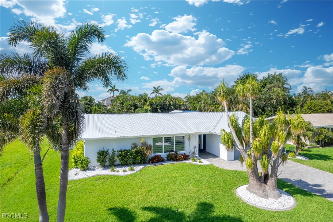 422 Coral Drive Cape Coral, FL 33904 - Photo 41 of 43 a front view of a house with garden