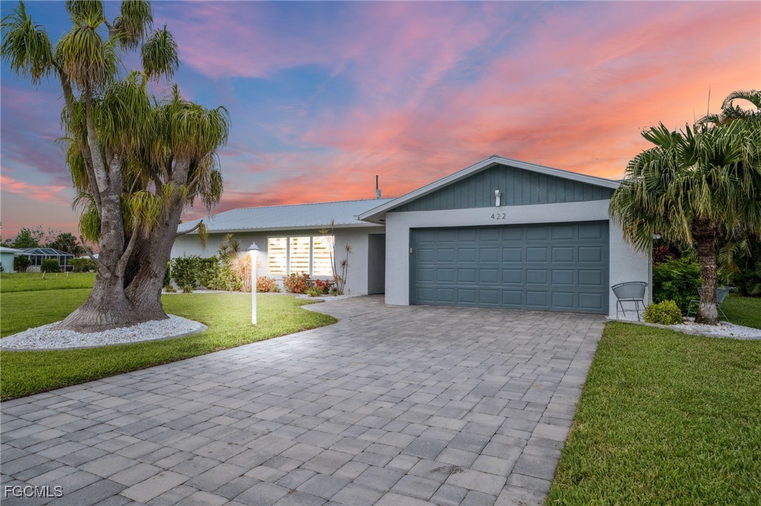 422 Coral Drive Cape Coral, FL 33904 - Photo 43 of 43 a front view of a house with garden