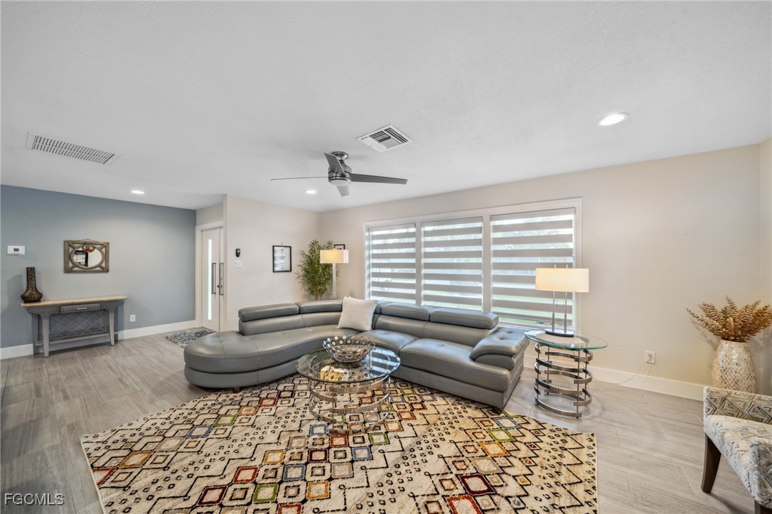 422 Coral Drive Cape Coral, FL 33904 - Photo 6 of 43 a living room with furniture and a rug