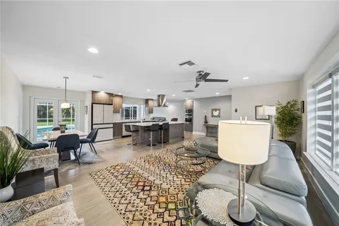 a living room with furniture a rug and white walls
