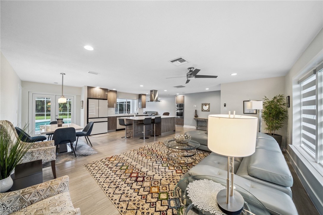 422 Coral Drive Cape Coral, FL 33904 - Photo 7 of 43 a living room with furniture a rug and white walls