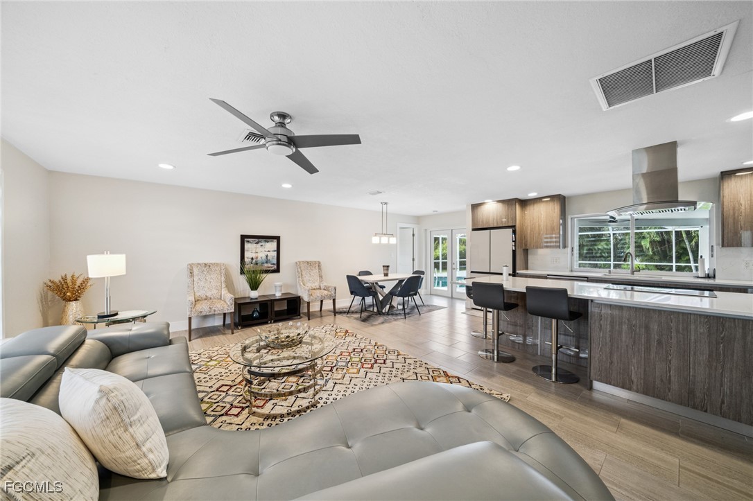 422 Coral Drive Cape Coral, FL 33904 - Photo 8 of 43 a living room with furniture kitchen view and a large window