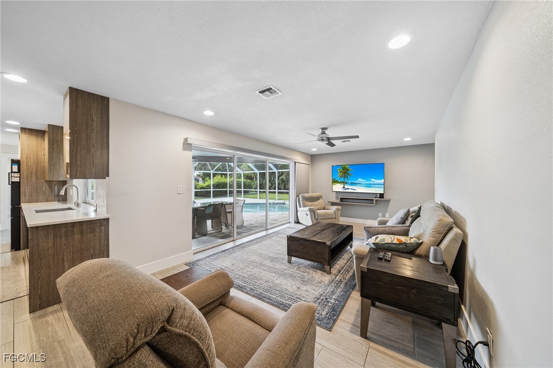 422 Coral Drive Cape Coral, FL 33904 - Photo 10 of 43 a living room with furniture and a large window
