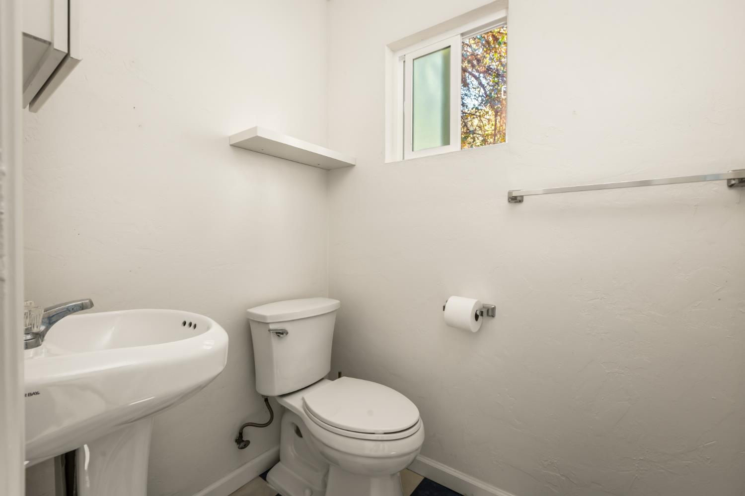 10875 Spenceville Road Penn Valley, CA 95946 - Photo 39 of 49 a white toilet sitting next to a white sink and a mirror