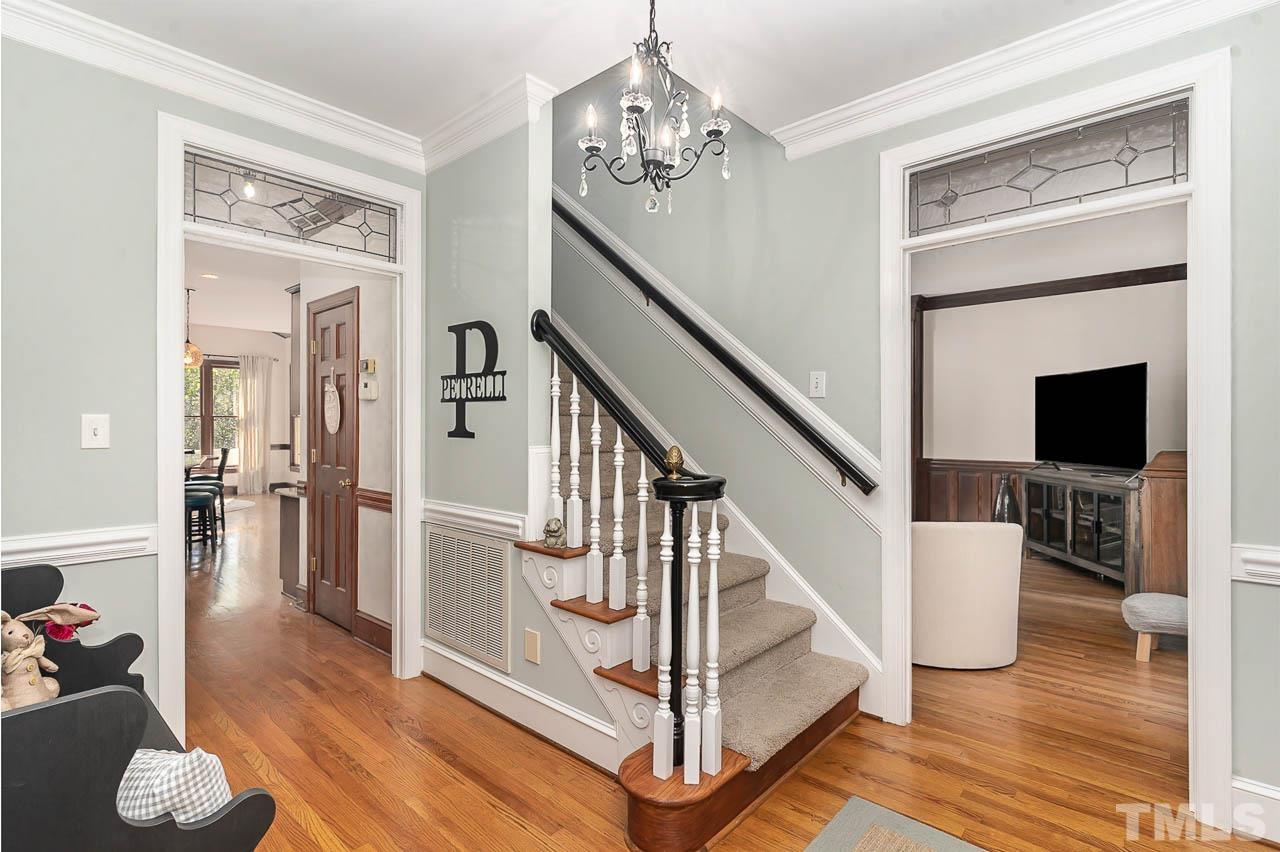 7512 Rainwater Road Raleigh, NC 27615 - Photo 13 of 45 a view of entryway with wooden floor and livingroom view