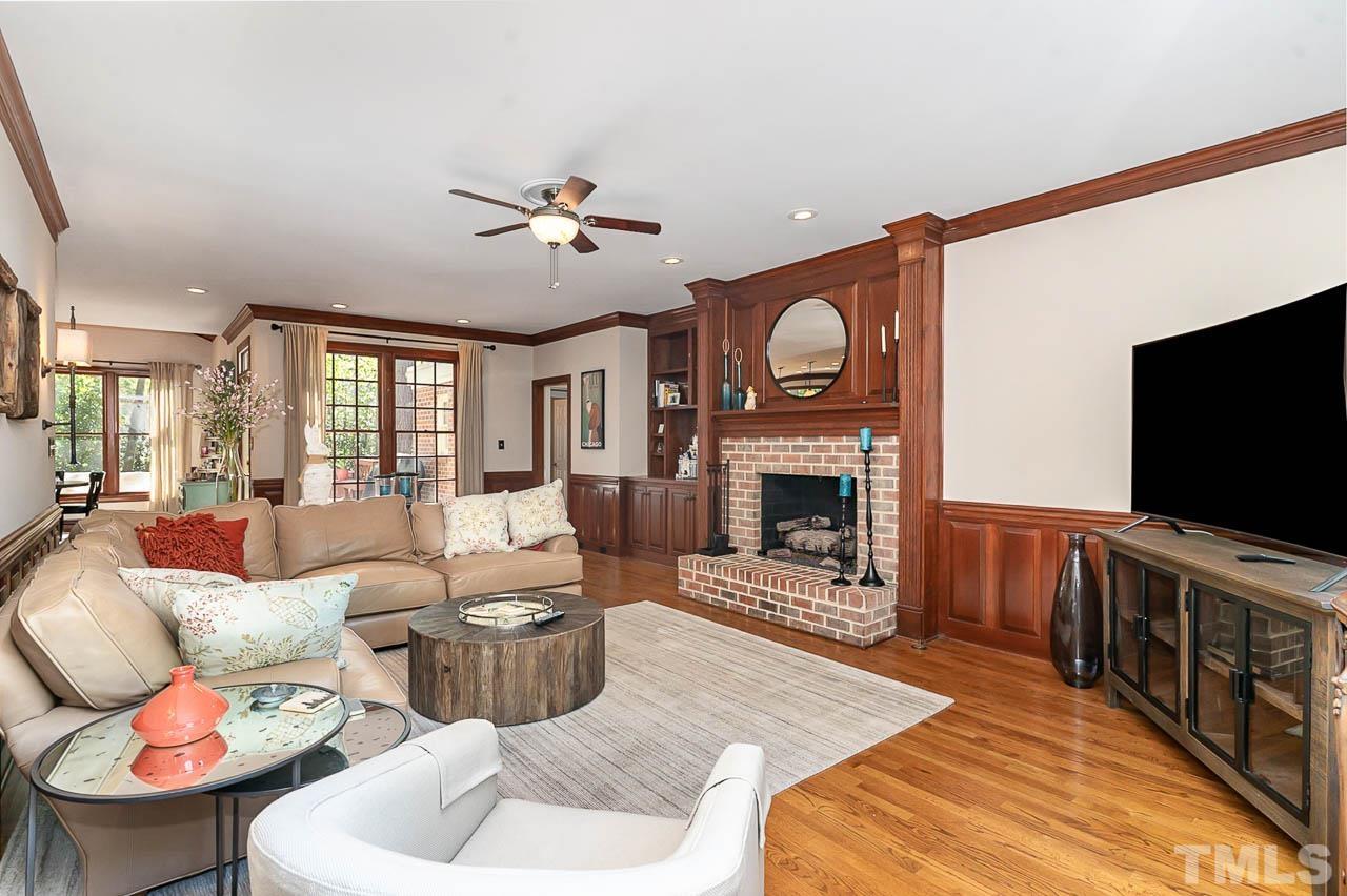 7512 Rainwater Road Raleigh, NC 27615 - Photo 15 of 45 a living room with furniture a flat screen tv and a fireplace