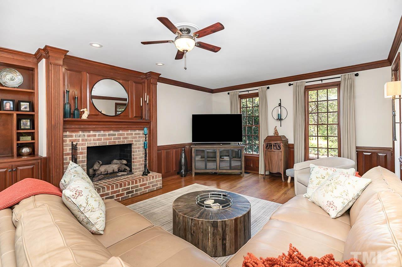 7512 Rainwater Road Raleigh, NC 27615 - Photo 17 of 45 a living room with furniture a flat screen tv and a fireplace