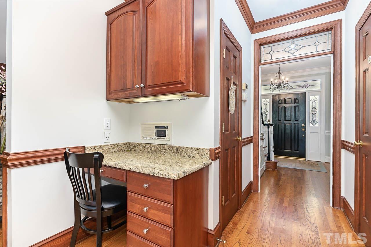 7512 Rainwater Road Raleigh, NC 27615 - Photo 25 of 45 a kitchen with a sink a refrigerator and wooden floor