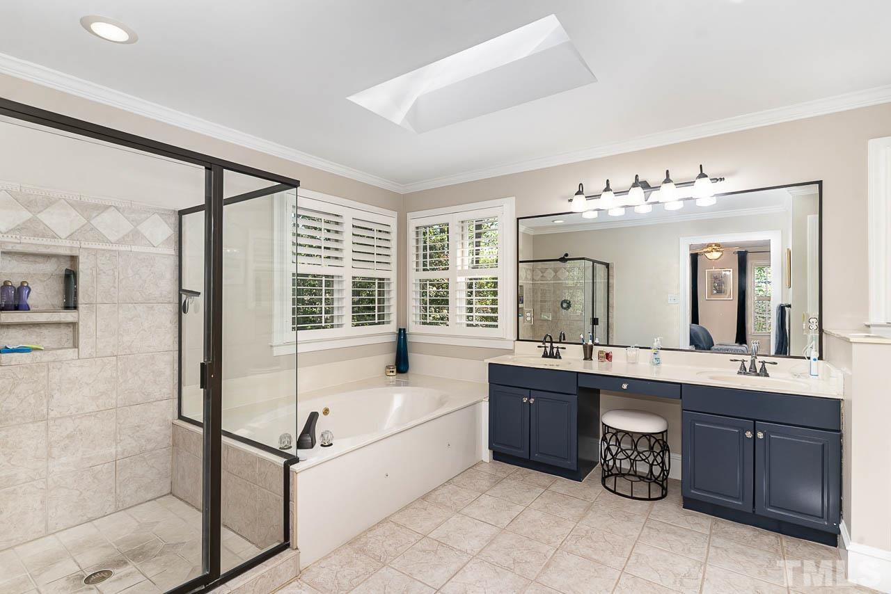 7512 Rainwater Road Raleigh, NC 27615 - Photo 34 of 45 a spacious bathroom with a tub sink and mirror
