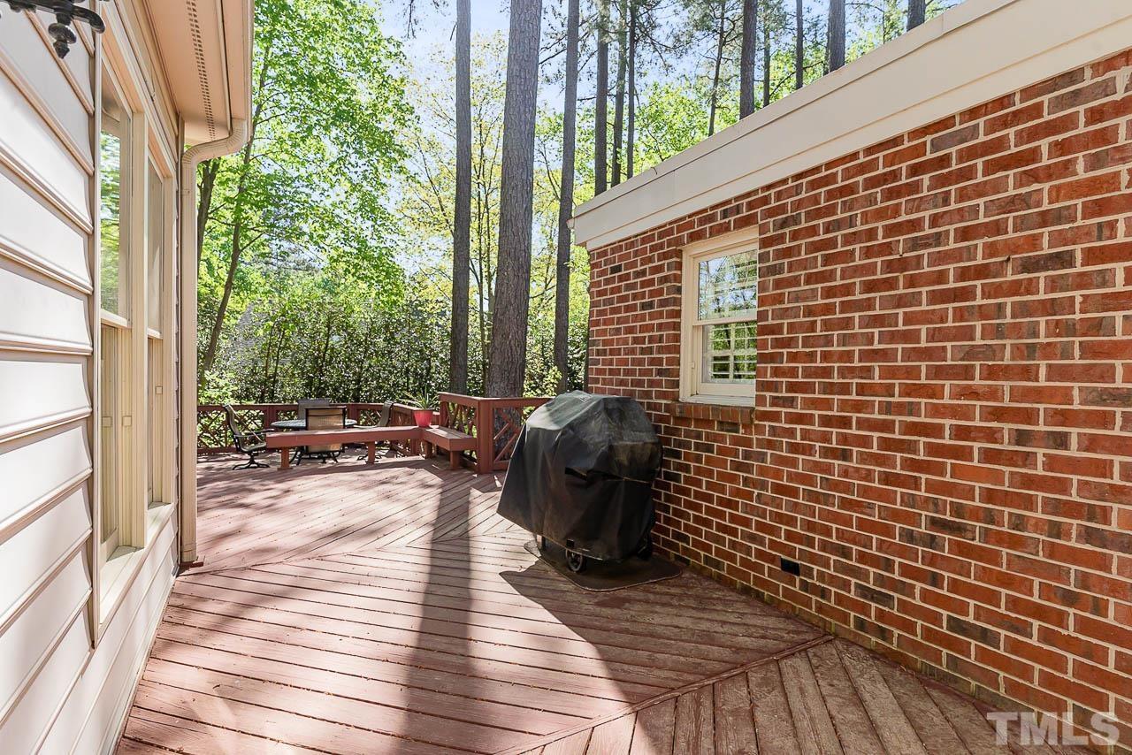 7512 Rainwater Road Raleigh, NC 27615 - Photo 7 of 45 a view of a balcony with chairs and wooden floor