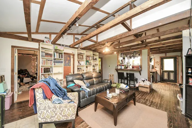 a living room with furniture and a chandelier