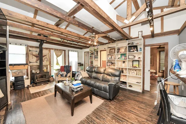 a living room with furniture a wooden floor and a chandelier