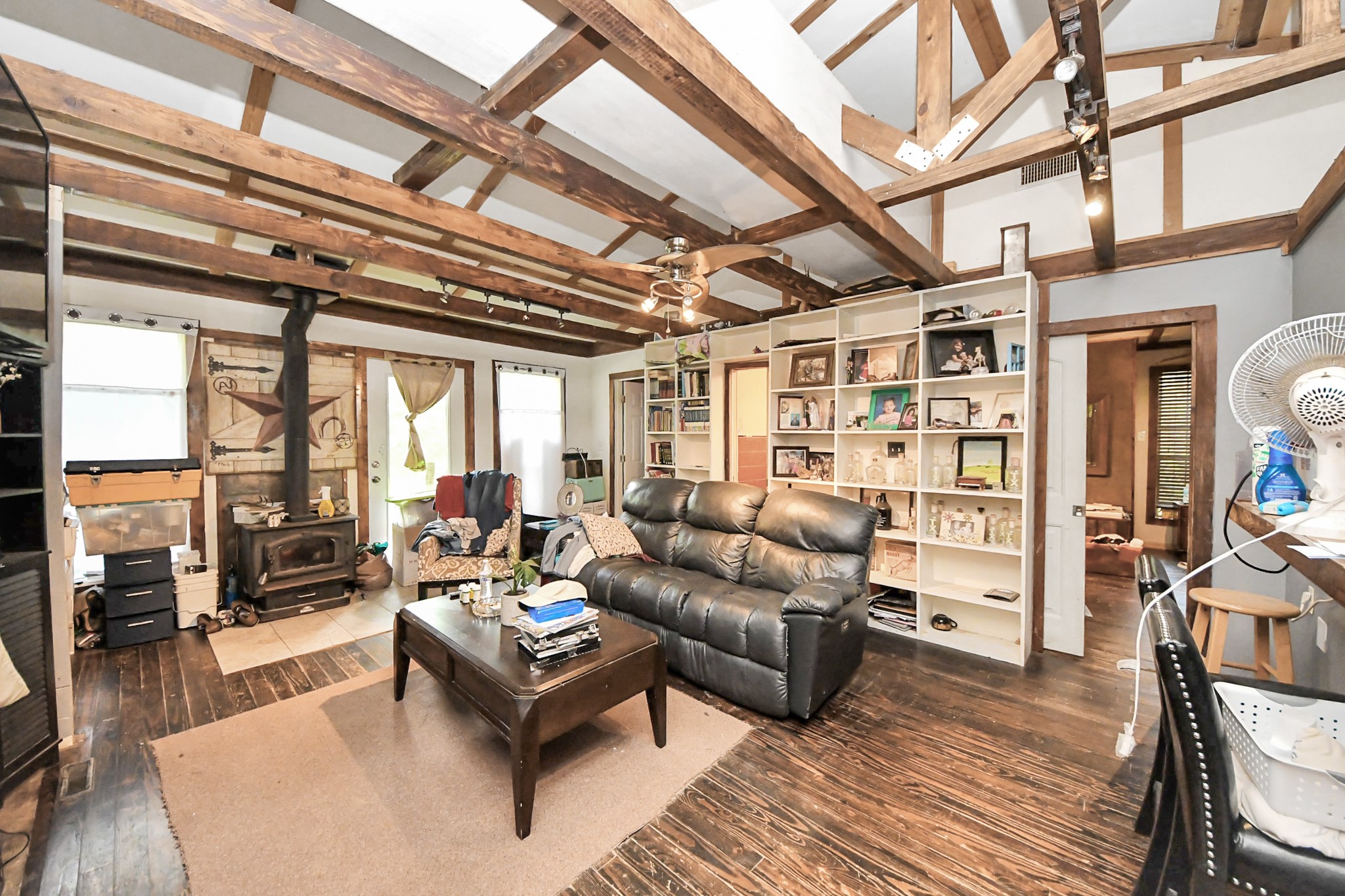 101 Rocky Road Livingston, TX 77351 - Photo 10 of 42 a living room with furniture a wooden floor and a chandelier