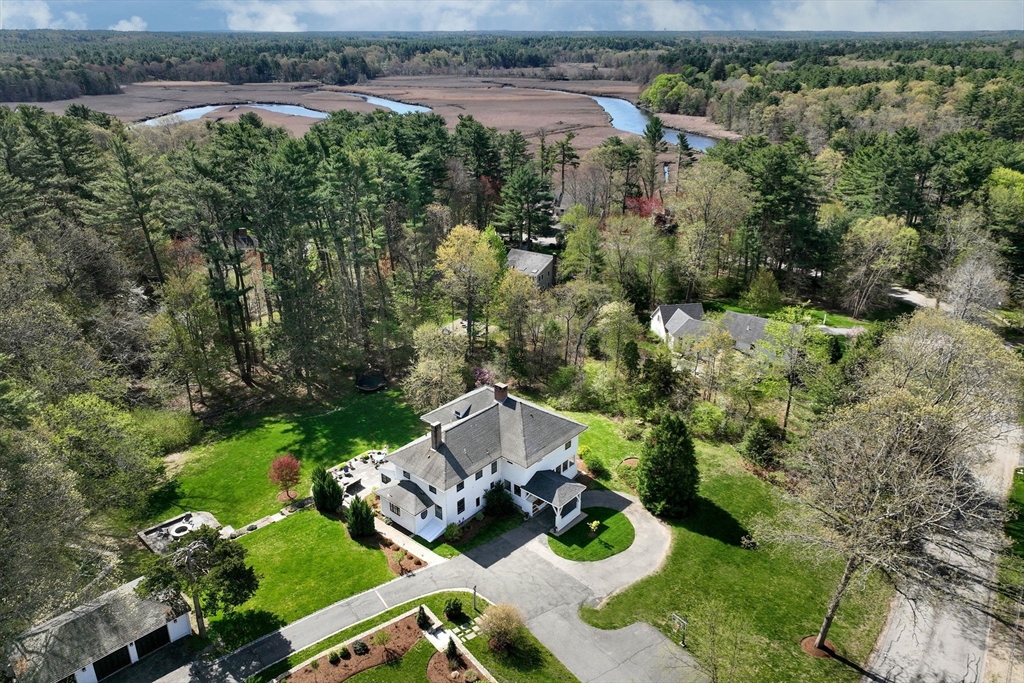 an aerial view of a house with yard lake and outdoor space