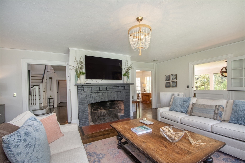 41 Brigantine Circle Norwell, MA 02061 - Photo 18 of 37 a living room with furniture a fireplace and a flat screen tv