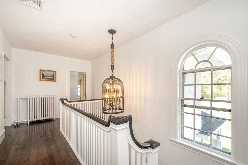 41 Brigantine Circle Norwell, MA 02061 - Photo 24 of 37 a view of a hallway with wooden floor windows and a kitchen view