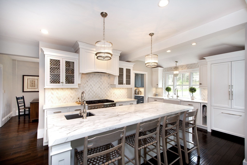 41 Brigantine Circle Norwell, MA 02061 - Photo 8 of 37 a kitchen with stainless steel appliances granite countertop a stove a refrigerator a sink a dining table and chairs with wooden floor