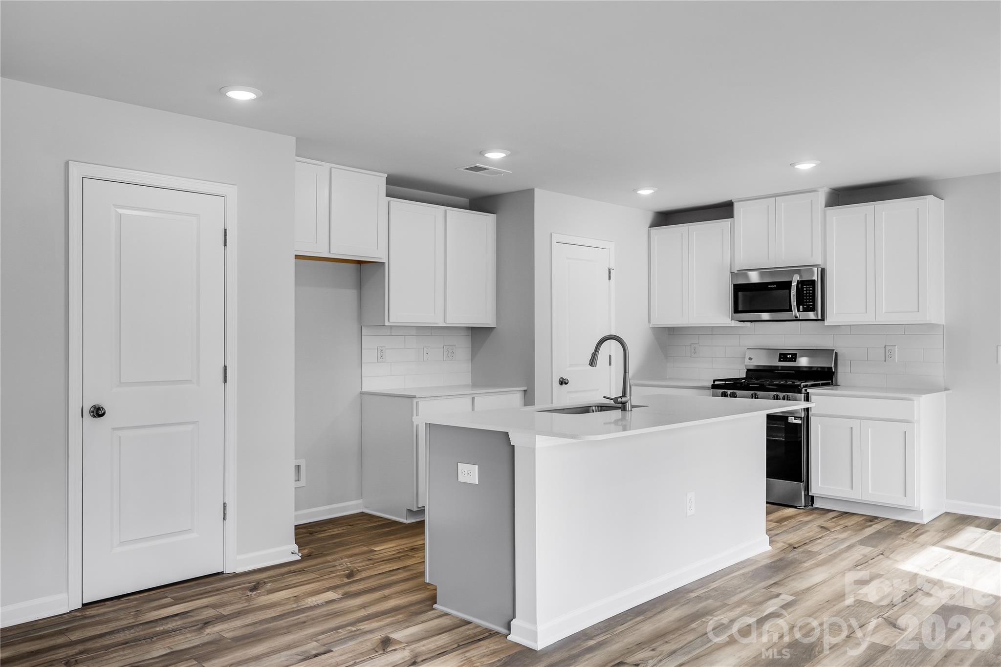 233 West 18th Street Kannapolis, NC 28081 - Photo 9 of 27 a kitchen with stainless steel appliances granite countertop a sink a stove a refrigerator and cabinets