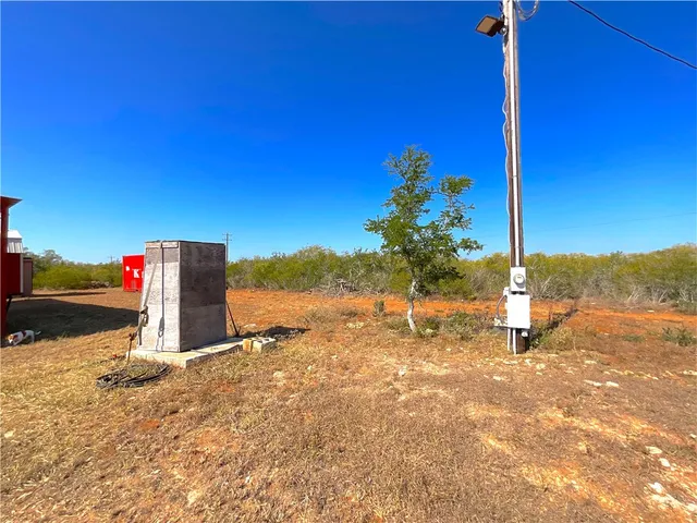 a view of a road with a house in the background