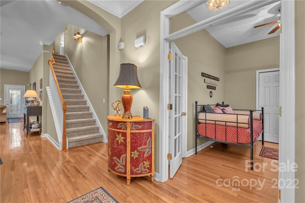 17018 Carlton Way Road Huntersville, NC 28078 - Photo 13 of 42 a view of a bedroom with wooden floor and furniture