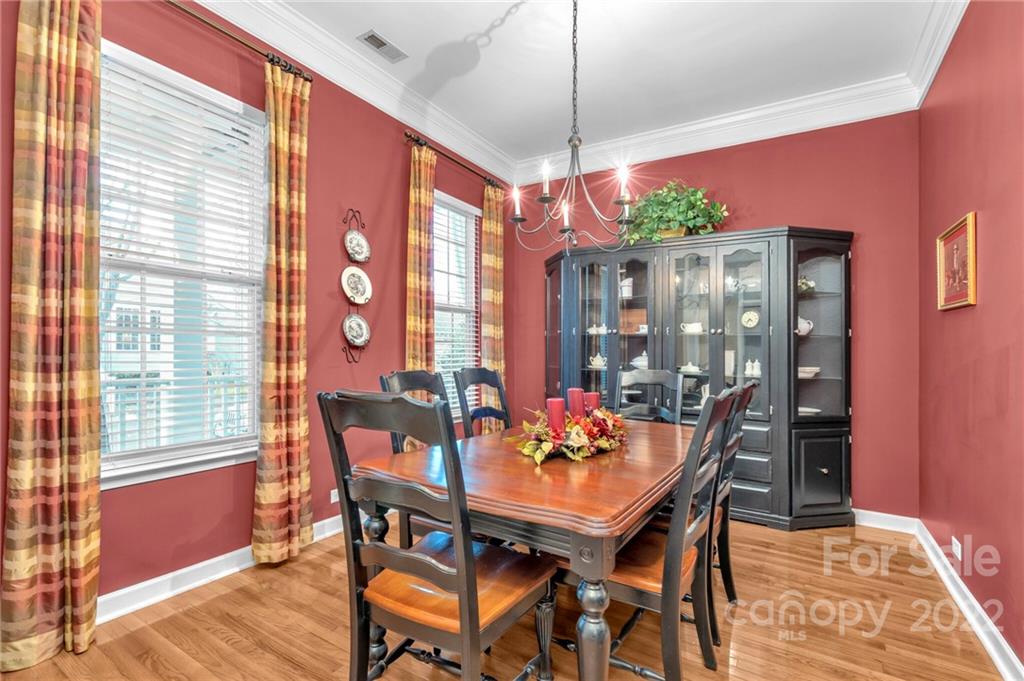 17018 Carlton Way Road Huntersville, NC 28078 - Photo 15 of 42 a view of a dining room with furniture window and wooden floor