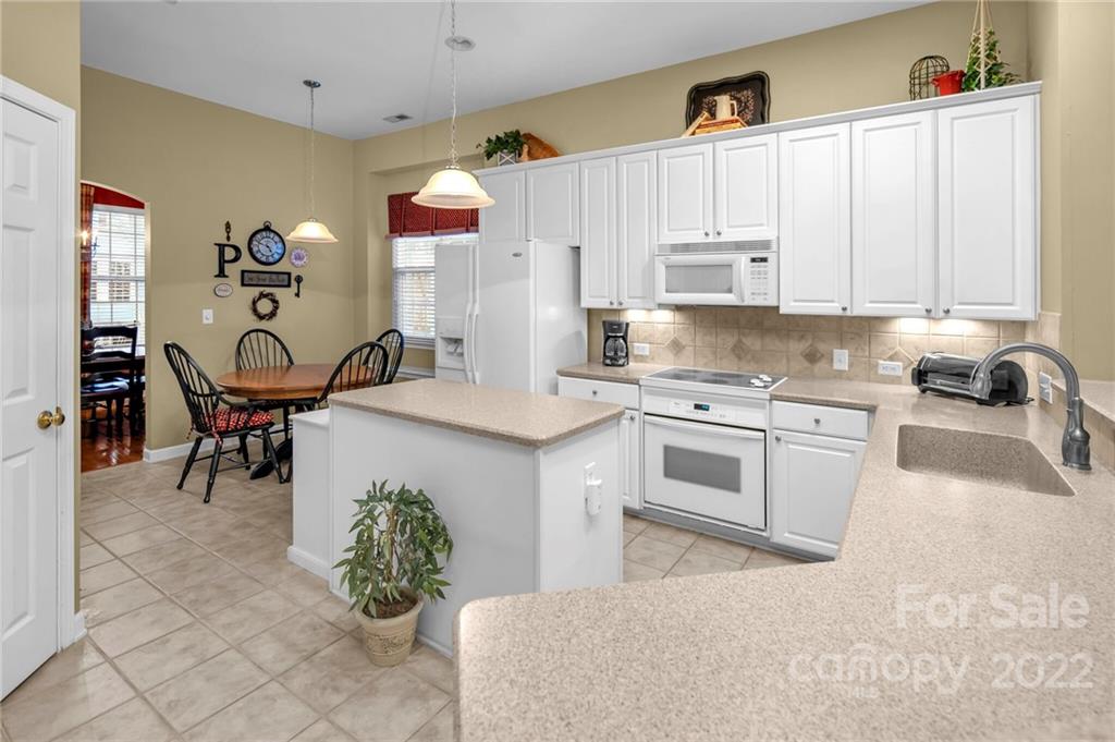 17018 Carlton Way Road Huntersville, NC 28078 - Photo 18 of 42 a kitchen with granite countertop a sink cabinets and window